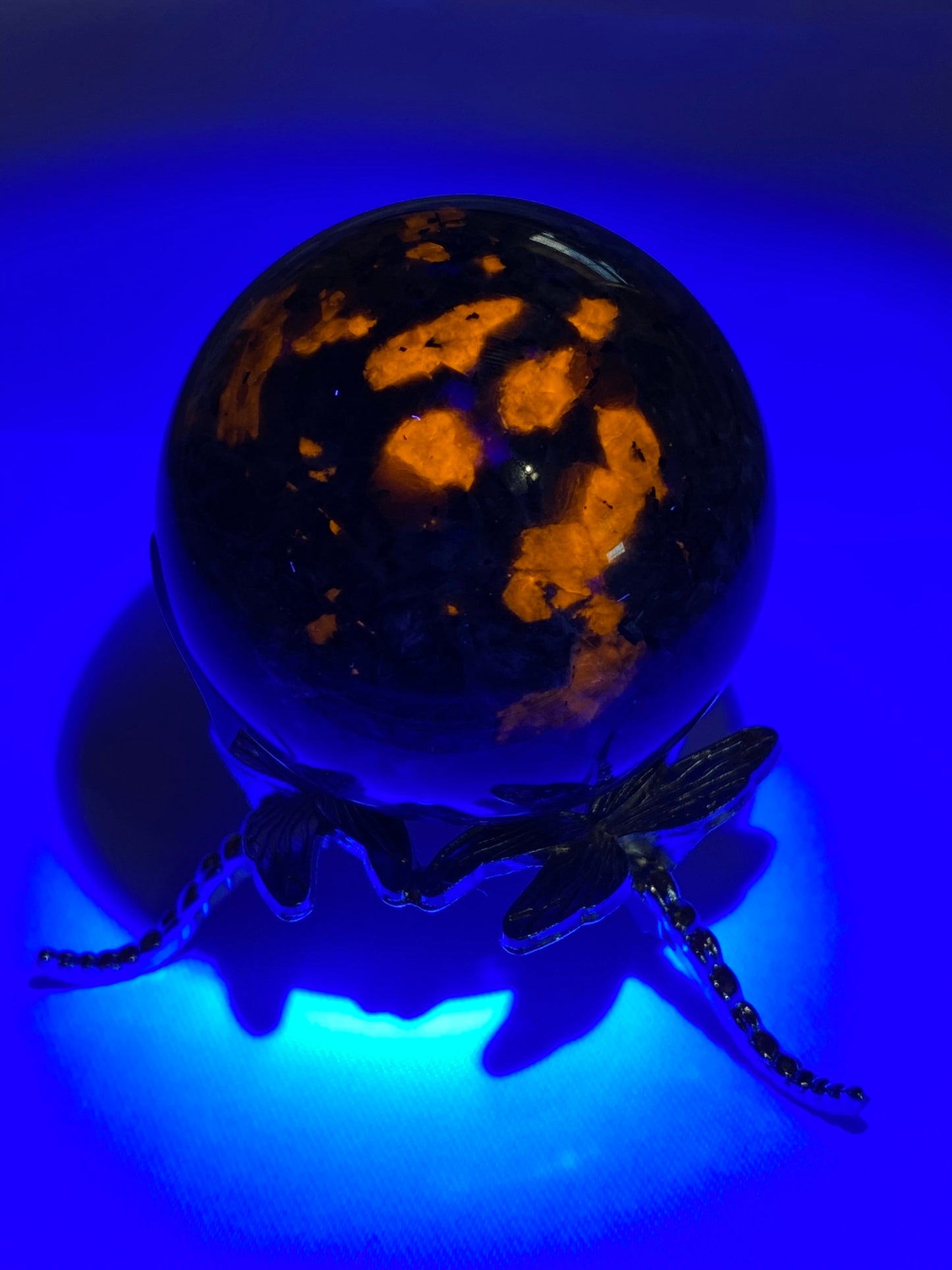 Yooperlite Sphere s4 (UV Reactive) - polished gray black stone sculpture glows red under blacklight