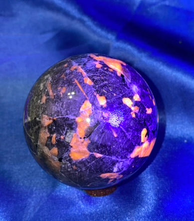 Yooperlite Sphere s8 (UV Reactive) - polished gray black stone sculpture glows red under blacklight